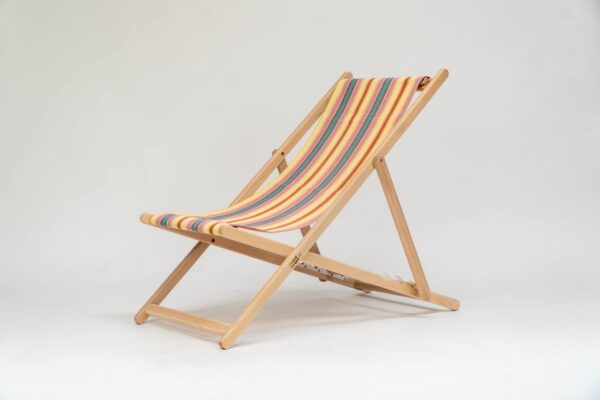 Beechwood Deckchair with Waltzing fabric, yellow, pink, green, lavendar and white stripes, viewed from at an angle - created by Decks and Stipes Ireland